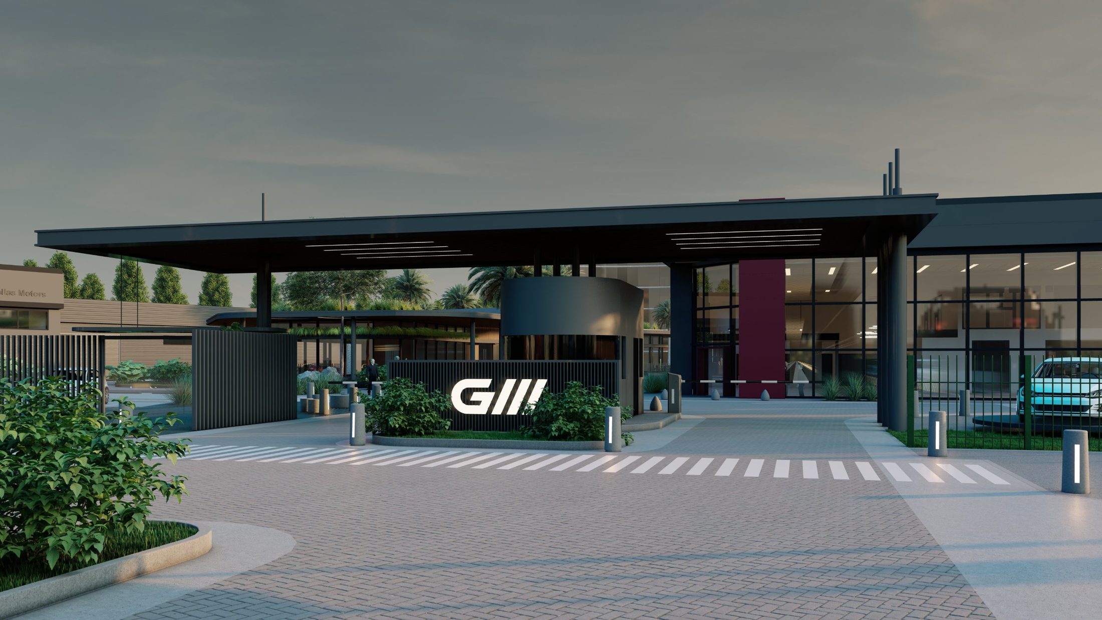 Complejo GM en Resistencia: acceso al anochecer con el logo de GM iluminado y la garita bajo un gran alero